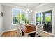 Inviting dining room with wood table, white chairs, stylish chandelier, and view of the deck at 3129 Burnello Ct, Iron Station, NC 28080