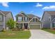 Charming two-story home with a well-manicured lawn and inviting curb appeal, painted in a neutral green tone at 3129 Burnello Ct, Iron Station, NC 28080