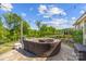 Cozy outdoor fire pit area with comfortable seating, perfect for relaxing evenings and gatherings, surrounded by lush greenery at 3129 Burnello Ct, Iron Station, NC 28080