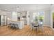 Open concept with a kitchen island, a dining table and stainless steel appliances at 3129 Burnello Ct, Iron Station, NC 28080