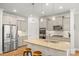 Open kitchen featuring granite countertops, stainless appliances, and bar stool seating at 3129 Burnello Ct, Iron Station, NC 28080