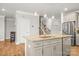 Kitchen island features granite counters, a stainless steel sink, and modern pendant lighting at 3129 Burnello Ct, Iron Station, NC 28080
