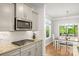 Modern kitchen with stainless appliances, granite countertops, and view to the dining area at 3129 Burnello Ct, Iron Station, NC 28080
