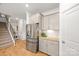 Kitchen with stainless steel refrigerator next to the staircase at 3129 Burnello Ct, Iron Station, NC 28080