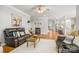 Inviting living room features a brown leather sofa and flows into a spacious, modern kitchen at 3129 Burnello Ct, Iron Station, NC 28080