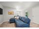 Comfortable living room features a plush blue sectional couch, creating a cozy and inviting space for relaxation and entertainment at 3129 Burnello Ct, Iron Station, NC 28080