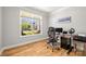 Home office with a work desk, hardwood floors, and a large window overlooking the neighborhood at 3129 Burnello Ct, Iron Station, NC 28080