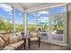 Bright sunroom featuring comfortable seating and views of the landscaped backyard and patio at 3129 Burnello Ct, Iron Station, NC 28080