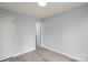 Light gray bedroom features modern flooring, trim, and access to bathroom at 313 Villa St, Kannapolis, NC 28083