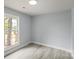 Bedroom showcasing a window with lots of natural light and wood-look floors at 313 Villa St, Kannapolis, NC 28083