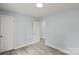 This bedroom features neutral paint, wood-look flooring, and two entry doors for easy access at 313 Villa St, Kannapolis, NC 28083
