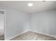 This bedroom features light gray walls, a modern light fixture, and stylish, light-colored flooring at 313 Villa St, Kannapolis, NC 28083