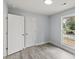 Bright bedroom features light gray walls, wood-look flooring, and a window with natural light at 313 Villa St, Kannapolis, NC 28083