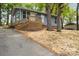 Charming single-story home features a new front porch, blue siding, and mature trees, offering a peaceful setting at 313 Villa St, Kannapolis, NC 28083