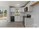 Modern kitchen with white cabinets, stainless steel appliances, and light countertops, offering a sleek and functional space at 313 Villa St, Kannapolis, NC 28083