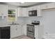 Modern kitchen with white cabinets, stainless steel appliances, and light countertops, offering a sleek and functional space at 313 Villa St, Kannapolis, NC 28083