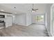 Open-concept living room features a ceiling fan and sleek gray wood-look flooring at 313 Villa St, Kannapolis, NC 28083