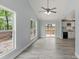 Bright living room boasts high ceilings, large windows, and modern flooring with adjacent deck at 313 Villa St, Kannapolis, NC 28083
