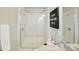 Modern bathroom featuring a tiled shower with a built-in bench and glass doors at 3216 Moss Ln, Charlotte, NC 28206