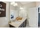 Bathroom featuring a double vanity with granite countertop, large mirror, and access to the bedroom at 3216 Moss Ln, Charlotte, NC 28206
