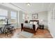 Bedroom features a dark wood sleigh bed, hardwood floors, tray ceiling, and three windows for plenty of natural light at 3216 Moss Ln, Charlotte, NC 28206