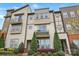 Attractive townhome facade with multiple windows, a balcony, and well-maintained landscaping at 3216 Moss Ln, Charlotte, NC 28206