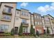 Charming townhome exterior with manicured landscaping, a balcony, and a welcoming entrance at 3216 Moss Ln, Charlotte, NC 28206