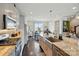 The kitchen features stainless appliances, a farmhouse sink, and an eat-in area, offering both style and functionality at 3216 Moss Ln, Charlotte, NC 28206