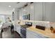 A kitchen features stainless appliances, gray cabinets, and granite countertops, combining modern aesthetics with practical features at 3216 Moss Ln, Charlotte, NC 28206
