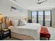 Bright main bedroom with plush upholstered bed, modern ceiling fan, and bright windows at 3216 Moss Ln, Charlotte, NC 28206