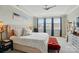 Main bedroom features tray ceiling, large windows with blue curtains, and stylish furniture, creating a bright, luxurious retreat at 3216 Moss Ln, Charlotte, NC 28206