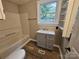 Bathroom featuring a single vanity, wood-look flooring, a shower/tub combination, and shelving at 3824 Freedom Dr, Charlotte, NC 28208