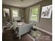 Charming bedroom featuring wall-to-wall carpet, neutral walls, and two large windows at 3824 Freedom Dr, Charlotte, NC 28208