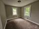 Bedroom features neutral paint, wall-to-wall carpeting, and large windows at 3824 Freedom Dr, Charlotte, NC 28208