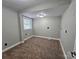 Neutral bedroom featuring wall-to-wall carpet, painted walls, and a window to let in natural light at 3824 Freedom Dr, Charlotte, NC 28208