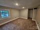 This bedroom features neutral walls, carpeted flooring, and a window providing natural light at 3824 Freedom Dr, Charlotte, NC 28208