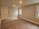 Spacious bedroom with carpeted floors, light walls and trim, and natural light at 3824 Freedom Dr, Charlotte, NC 28208