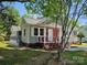 Cozy home with red brick and gray siding, featuring a welcoming front porch at 3824 Freedom Dr, Charlotte, NC 28208