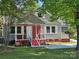Charming two-story home with a welcoming front porch and well-maintained lawn at 3824 Freedom Dr, Charlotte, NC 28208