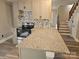 Modern kitchen featuring granite countertops, an island, and gray cabinets at 3824 Freedom Dr, Charlotte, NC 28208