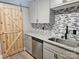 Beautiful kitchen with gray cabinets, granite countertops, stainless steel appliances, and a modern barn door at 3824 Freedom Dr, Charlotte, NC 28208