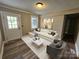 Bright living room features wood-look flooring, neutral paint, and stylish staging at 3824 Freedom Dr, Charlotte, NC 28208