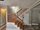 Staircase features wood railings and white risers, and wood-look flooring on the landing at 3824 Freedom Dr, Charlotte, NC 28208