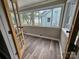 Bright sunroom featuring large windows and wood-look floors; perfect for enjoying natural light and outdoor views at 3824 Freedom Dr, Charlotte, NC 28208