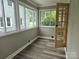 Inviting sunroom bathed in natural light, showcasing a serene space with wood-look floors and ample windows at 3824 Freedom Dr, Charlotte, NC 28208