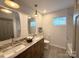 Bright bathroom featuring a double sink vanity with granite counters and modern lighting fixtures at 401 Baker St, Gastonia, NC 28052
