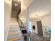 Bright entryway boasts hardwood floors, staircase, and elegant chandelier lighting at 401 Baker St, Gastonia, NC 28052