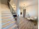 Bright entryway boasts hardwood floors, staircase, and elegant chandelier lighting at 401 Baker St, Gastonia, NC 28052