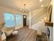 Bright living room with hardwood floors, large windows, and modern chandelier at 401 Baker St, Gastonia, NC 28052