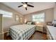 Bright bedroom featuring two windows, neutral walls, and a comfortable plaid bedspread at 4224 Firwood Ln, Charlotte, NC 28209